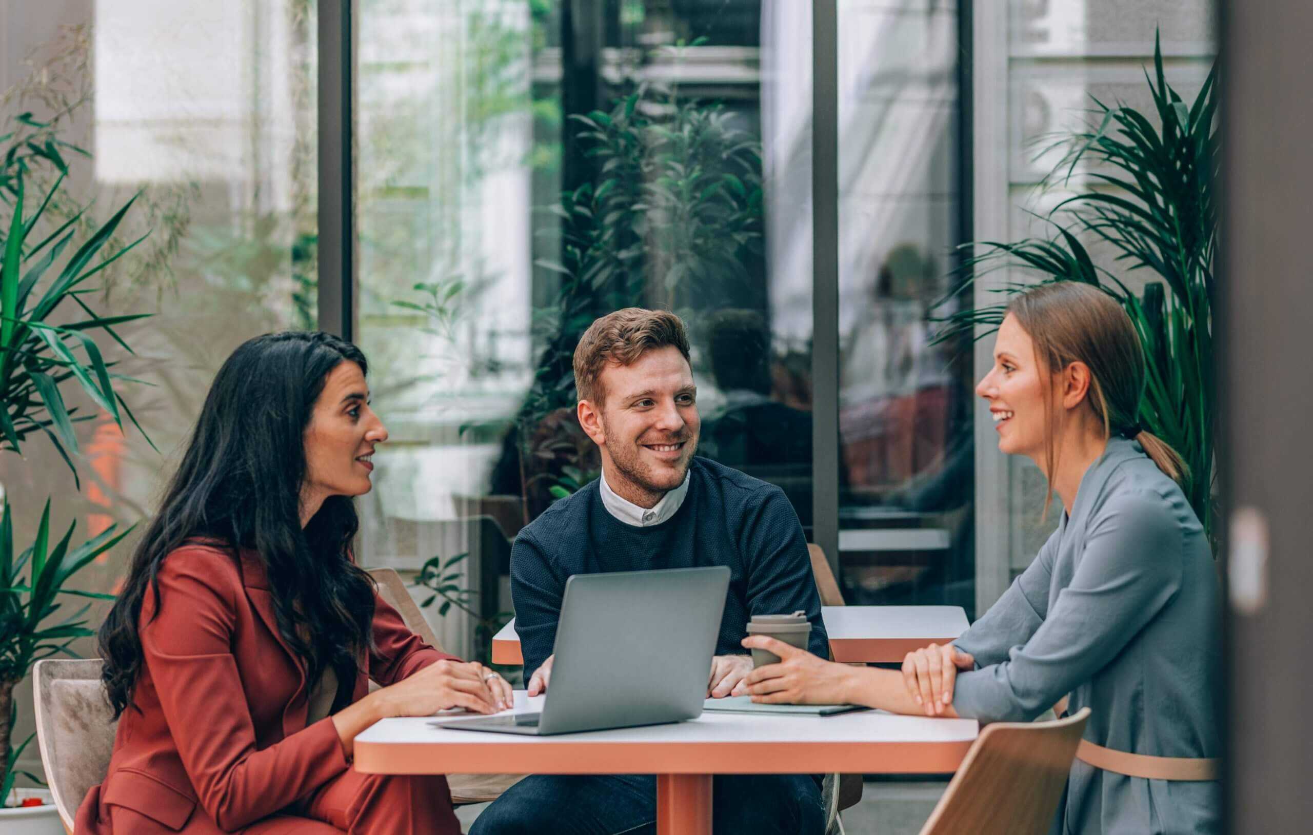 a group of young professionals in a casual meeting discussing corvel benefits